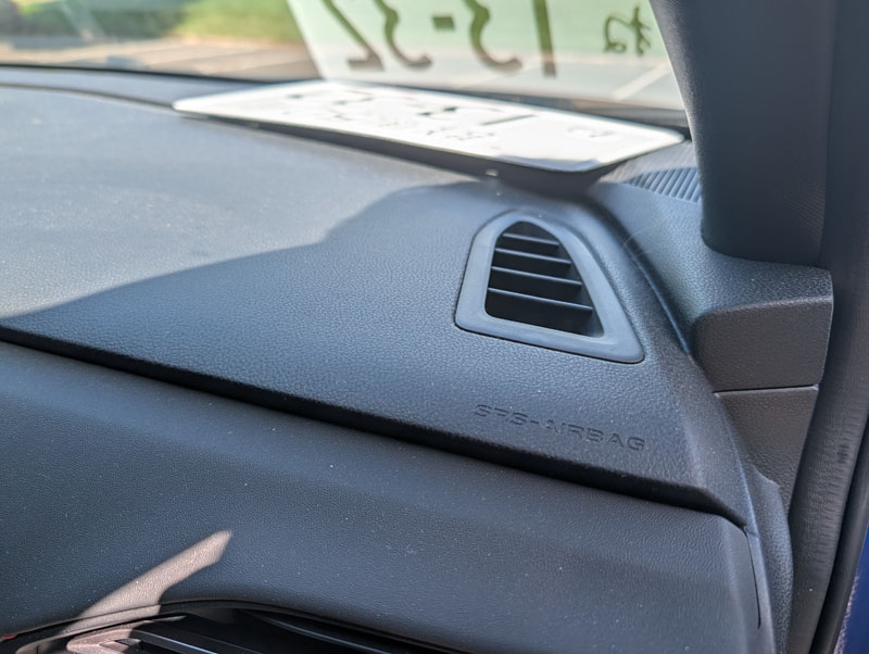 Demonstrating a mounting position on the passenger side where the plate would interfere with the passenger airbag.